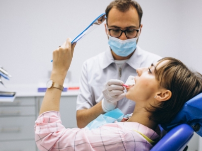 dentist checking on woman's tooth