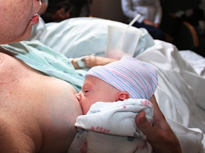 newborn baby being breastfed in hospital