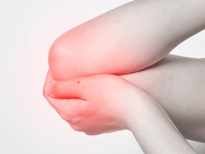woman holding elbows muscle pain